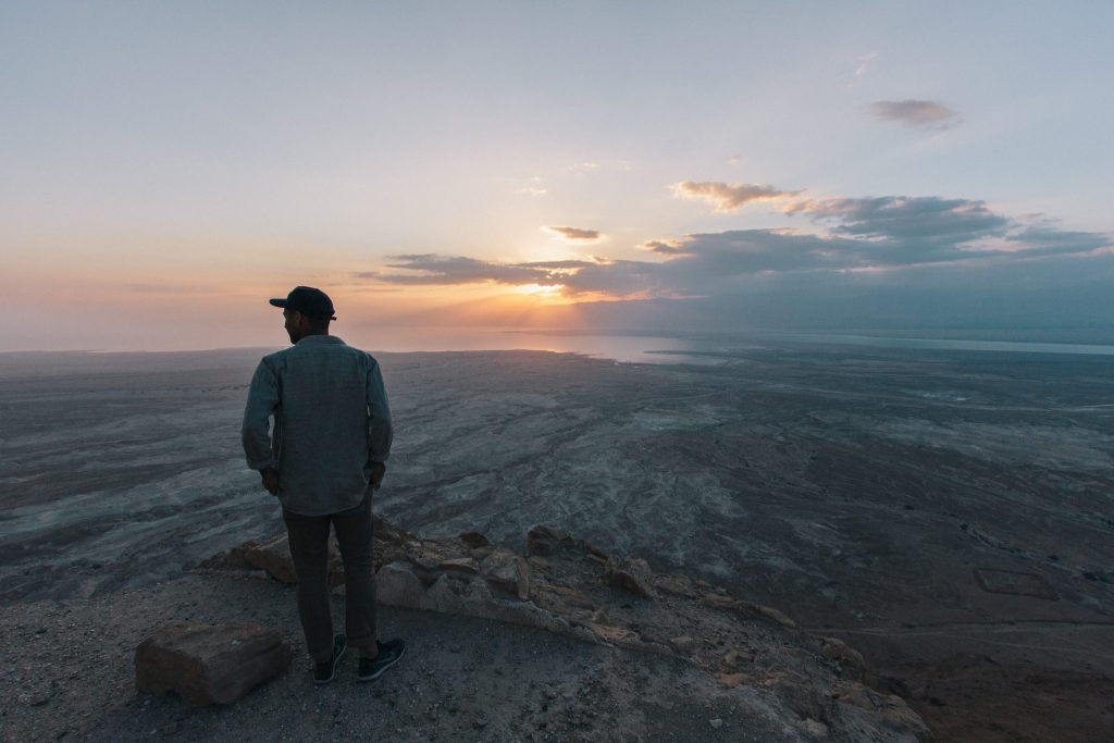 man overlooking the Dead Sea at sunrise in Israel