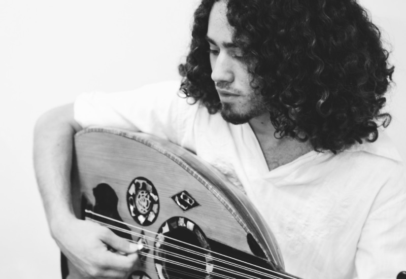 man playing a middle eastern instrument
