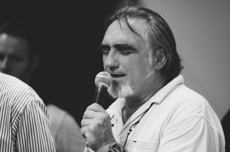 man praying into the microphone