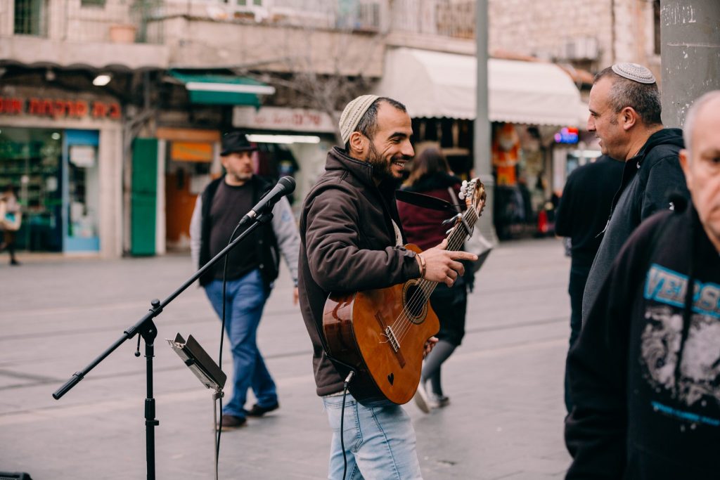 israeli playing music on a street corner