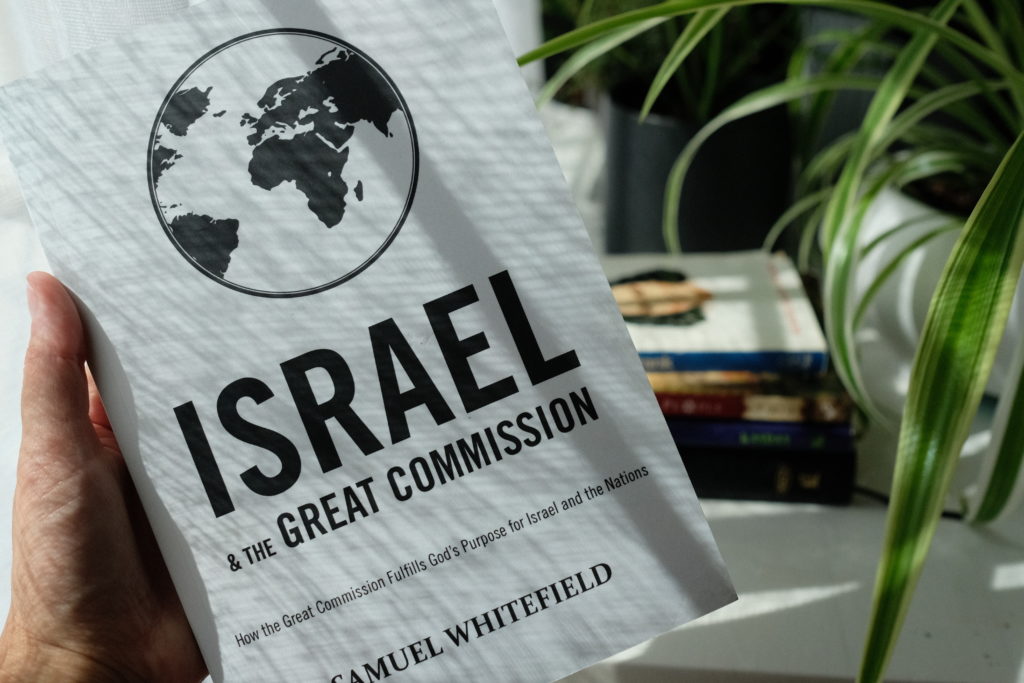 hand holding Israel and the Great Commission