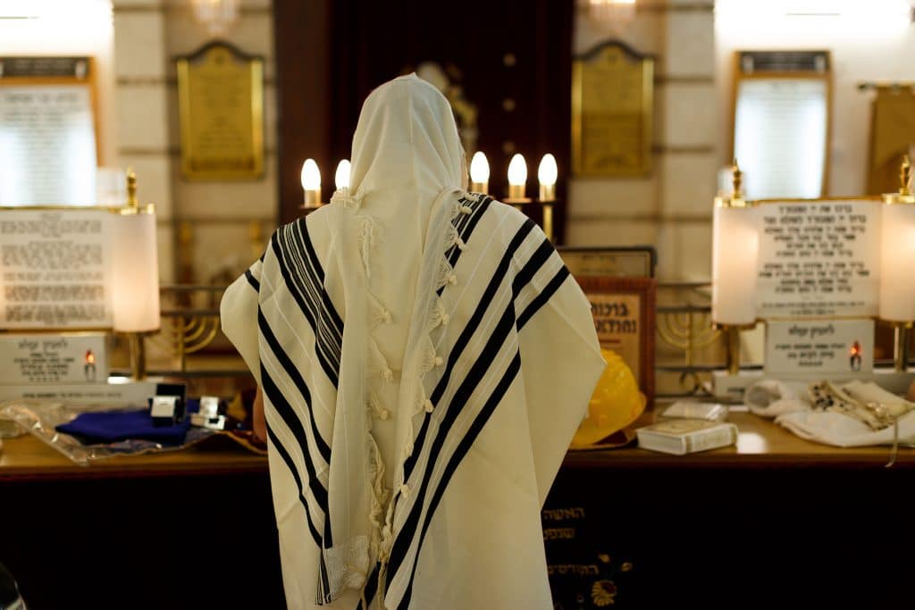 man doing prayers in a synagogue