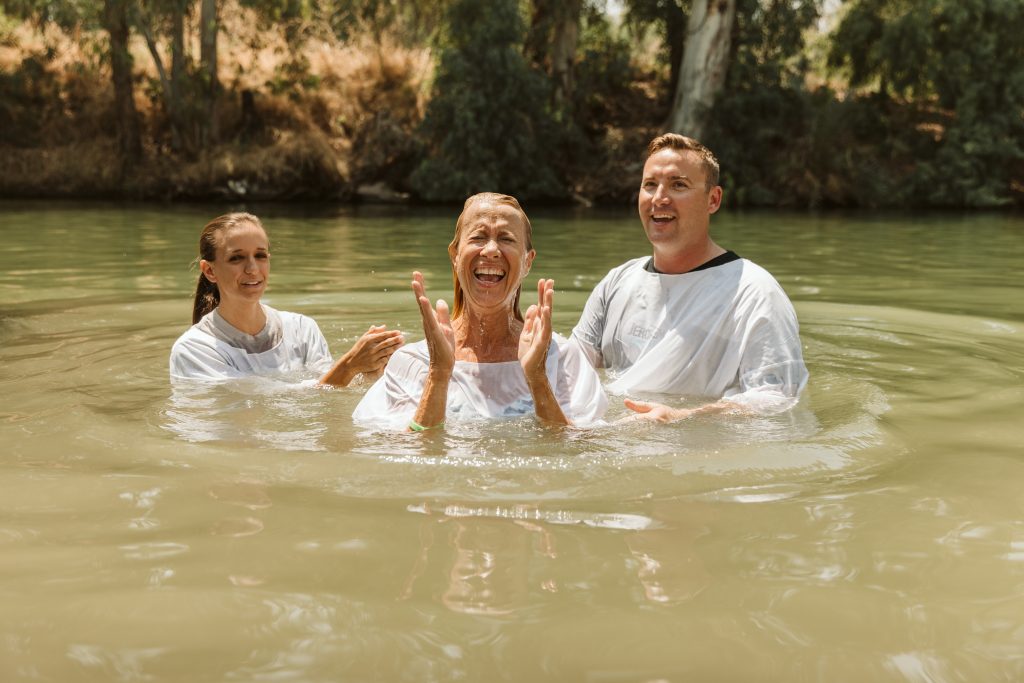 christians getting baptized in the jordan river